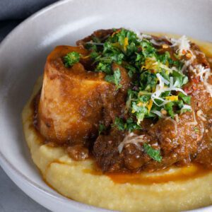 Pomegranate Braised Sonoma County Lamb and Mushroom Ragout with Pumpkin Polenta, Kale Salsa Verde and Spiced Pumpkin Seeds