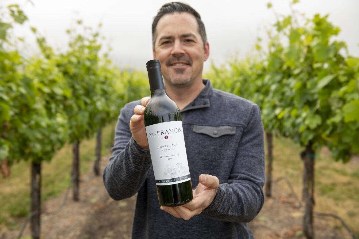 Chris Louton holding Cuvee Lago